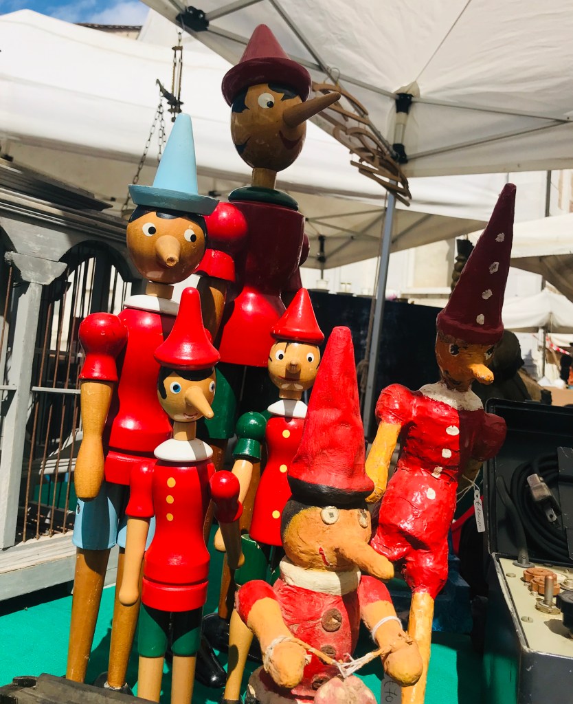 Pinocchi in vendita al mercato dell'antiquariato - Lucca, Toscana, Italia
